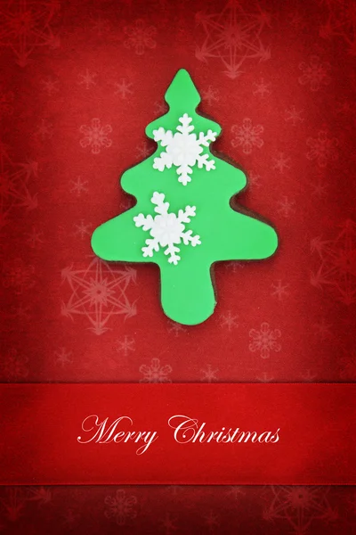 Christmas card with tree cookie on red background — Stock Photo, Image