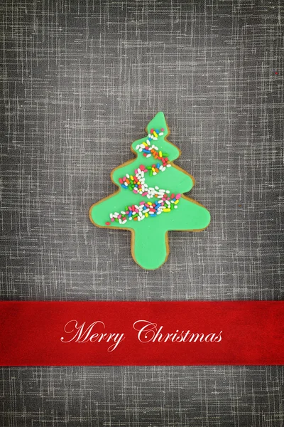 Christmas card with tree cookie on fabric background — Stock Photo, Image