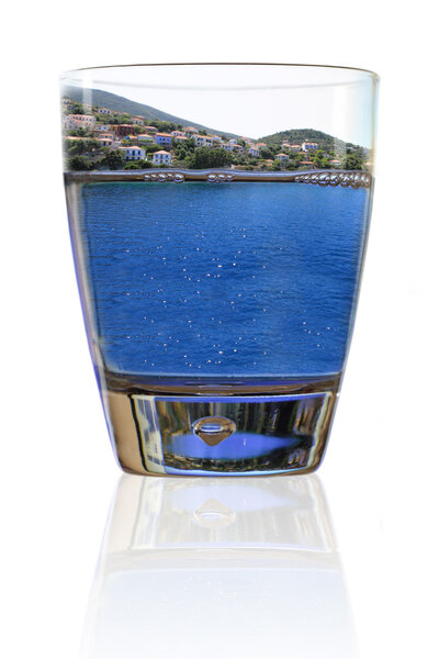 Glass of vacation. Greek island in a glass of water