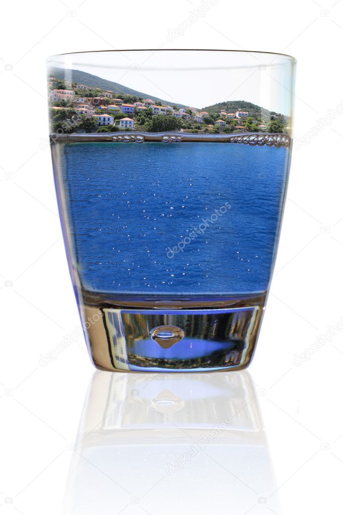 Glass of vacation. Greek island in a glass of water