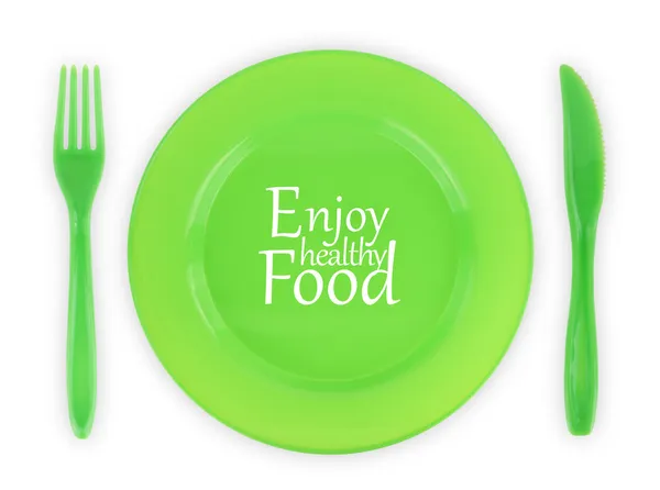 Green plate with fork and knife isolated on white — Stock Photo, Image
