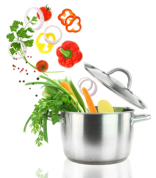 Fresh vegetables falling into a stainless steel casserole pot — Stock Photo, Image