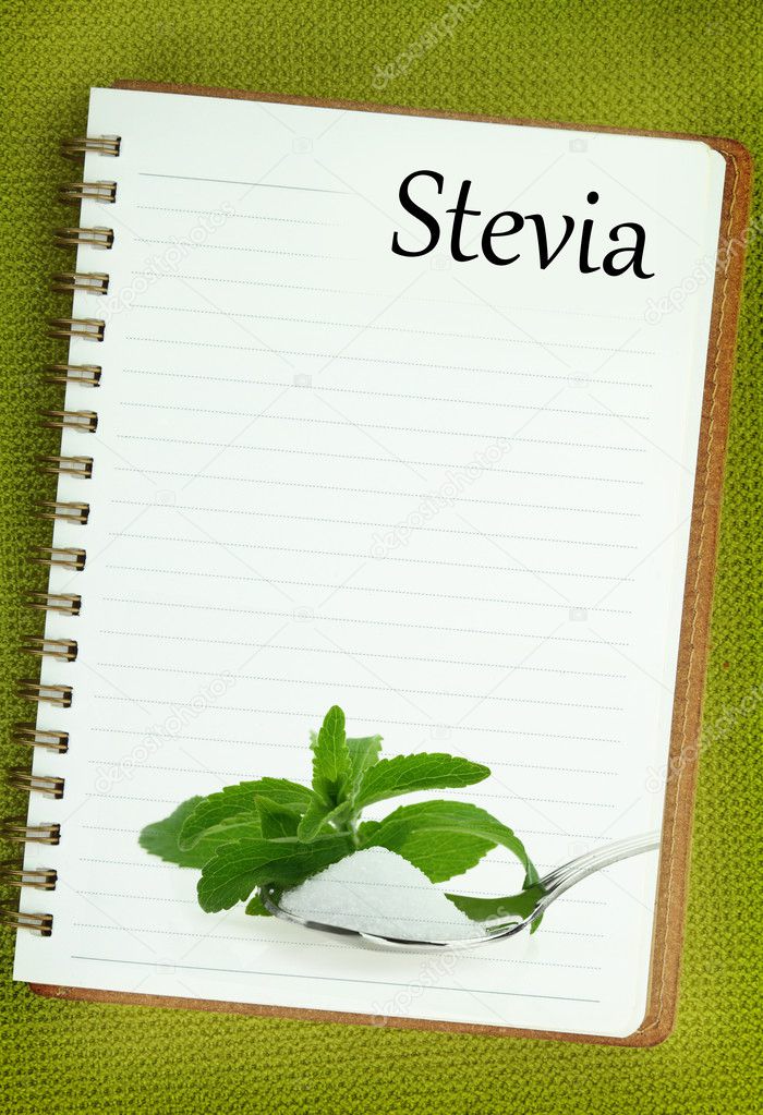 Fresh Stevia Rebaudiana and sugar on blank notebook page