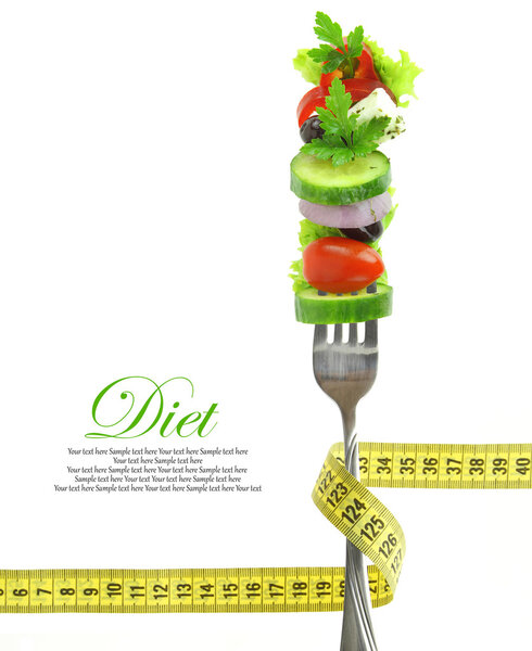 Fresh mixed vegetables on fork with measuring tape