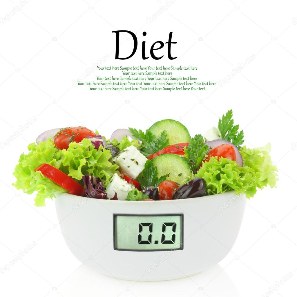Diet meal. Vegetables salad in a bowl with digital weight scale