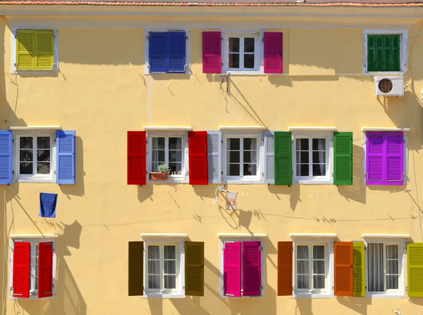 Colorful windows with louvered shutters — Stock Photo, Image