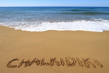 Chalkidiki written on sandy beach clipart
