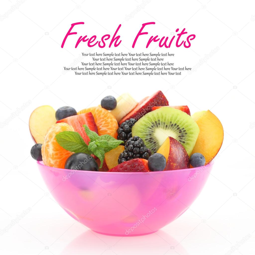 Fresh mixed fruit salad in a pink bowl