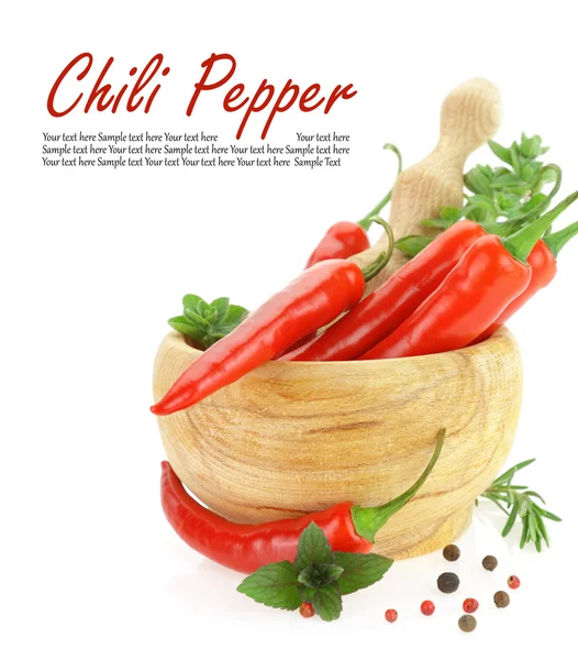 Red hot chili peppers with herbs in wooden mortar — Stock Photo, Image