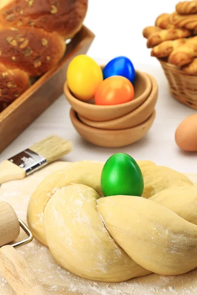 Easter sweet bread dough with multicolored eggs — Stock Photo, Image