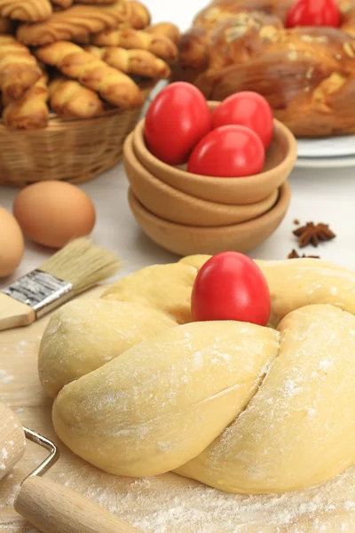 Easter sweet bread dough with red eggs Stock Image