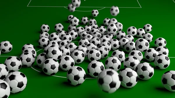 Bolas de futebol na grama verde — Fotografia de Stock