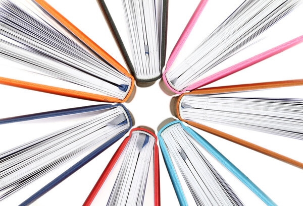 Top view of colorful books in a circle on white background