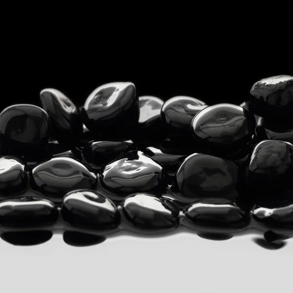 Zwarte stenen op kalm water achtergrond — Stockfoto