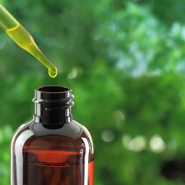 Dropper over essential oil bottle Stock Photo