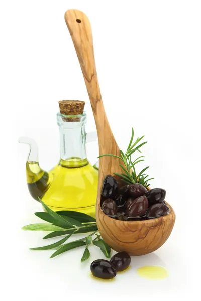 Olives in a wooden spoon and a bottle of virgin olive oil on white background — Stock Photo, Image