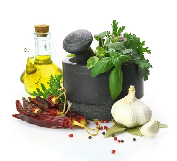 Black stone mortar and pestle with fresh herbs — Stock Photo, Image