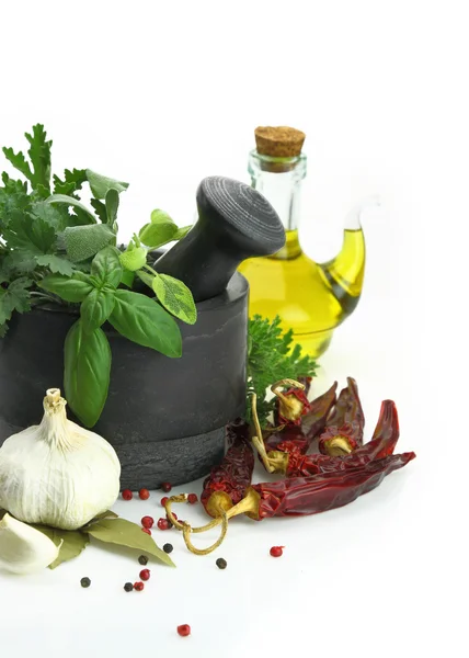 Black stone mortar and pestle with fresh herbs — Stock Photo, Image