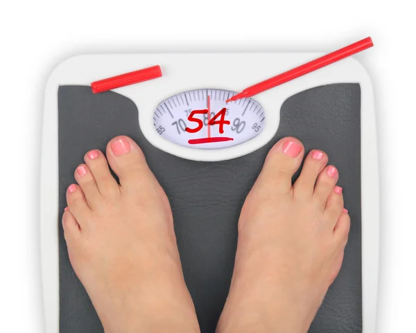 Woman' s feet on bathroom scale — Stock Photo, Image