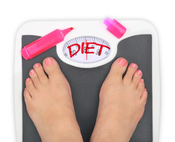 Woman' s feet on bathroom scale — Stock Photo, Image