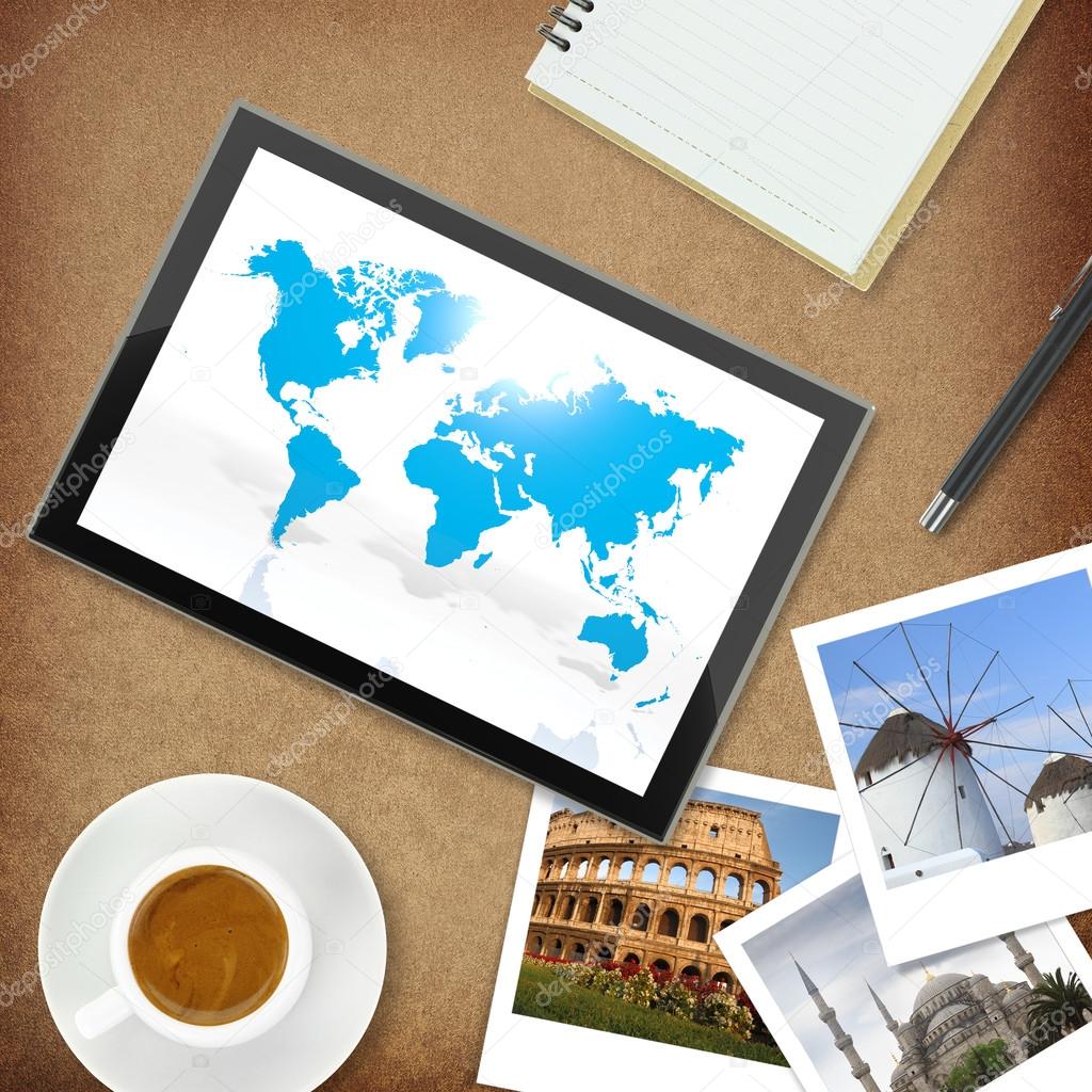 Tablet computer with world map and photos of famous places