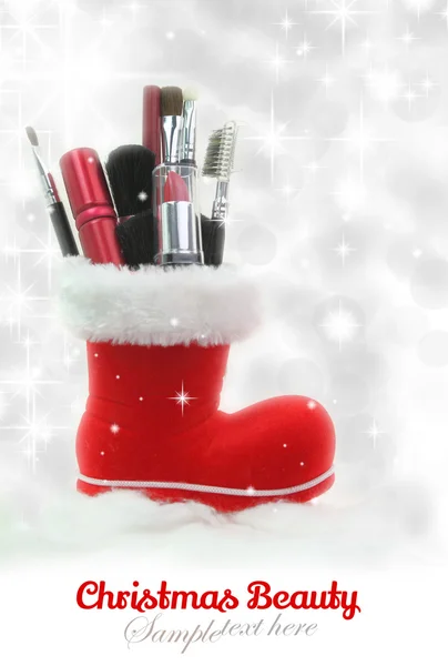 Santa Claus boot stuffed with woman cosmetics — Stock Photo, Image