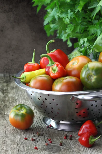 Vintage moody background with vegetables in colander — Stock Photo, Image