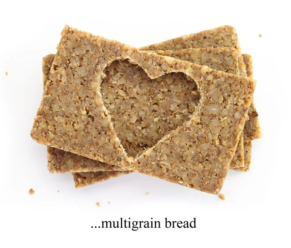 Stack di fette di pane multigrano, con forma di cuore ritagliato, isolato su bianco — Foto Stock