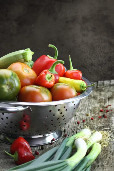 Vintage moody background with vegetables in colander — Stock Photo, Image