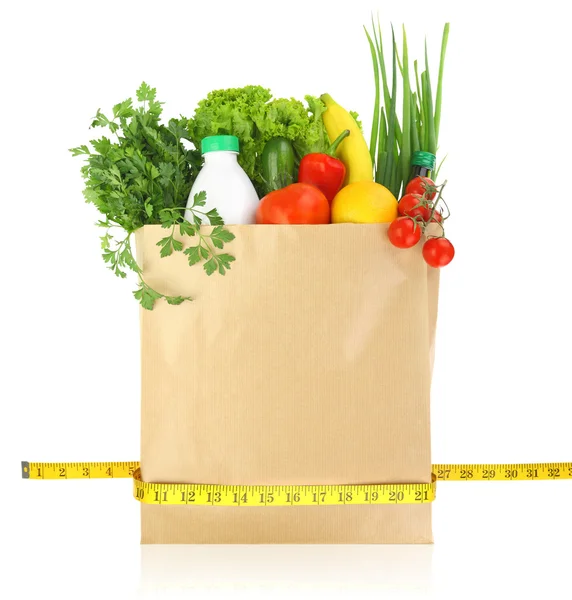 Fresh groceries in a paper bag with measuring tape — Stock Photo, Image
