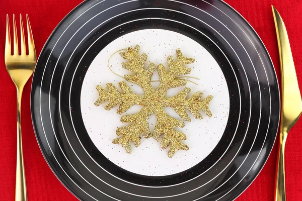 Christmas golden snowflake on a plate — Stock Photo, Image