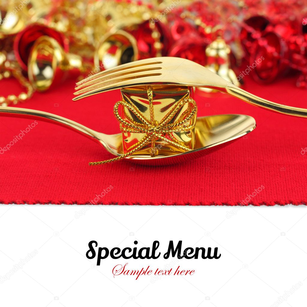 Christmas golden cutlery with ornament on red background