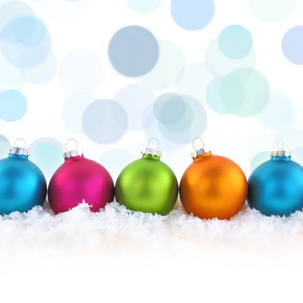 Colorful Christmas balls on the snow — Stock Photo, Image