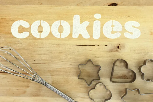 Stencil word "cookies" made with flour on wooden table — Stock Photo, Image