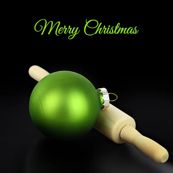 Christmas ball with rolling pin on black background — Stock Photo, Image