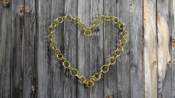 Golden chain in shape of heart, on wooden background — Stock Photo, Image