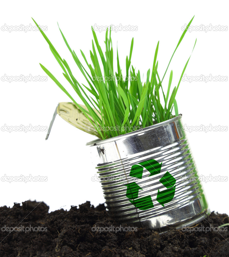 Can with recycle sign and growing grass on soil