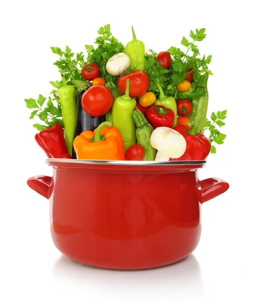 Colorful vegetables in a red cooking pot isolated on white background — Stock Image Colorful vegetables in a red cooking pot isolated on white background Royalty Free Stock Images