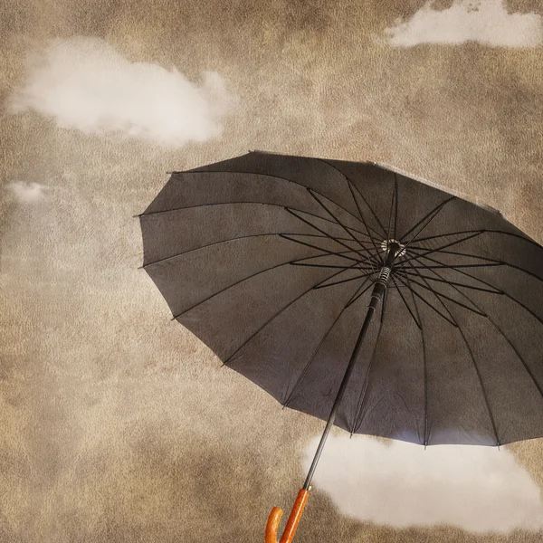 Fun flying umbrella on grungy background with clouds — Stock Photo, Image