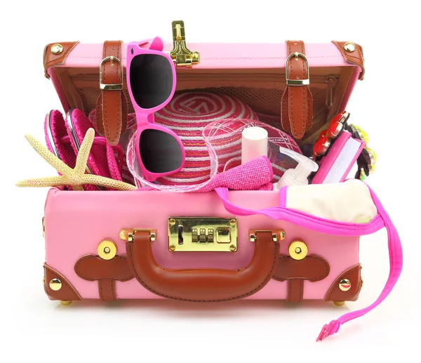 Ready to travel pink suitcase with summer equipment isolated — Stock Photo, Image