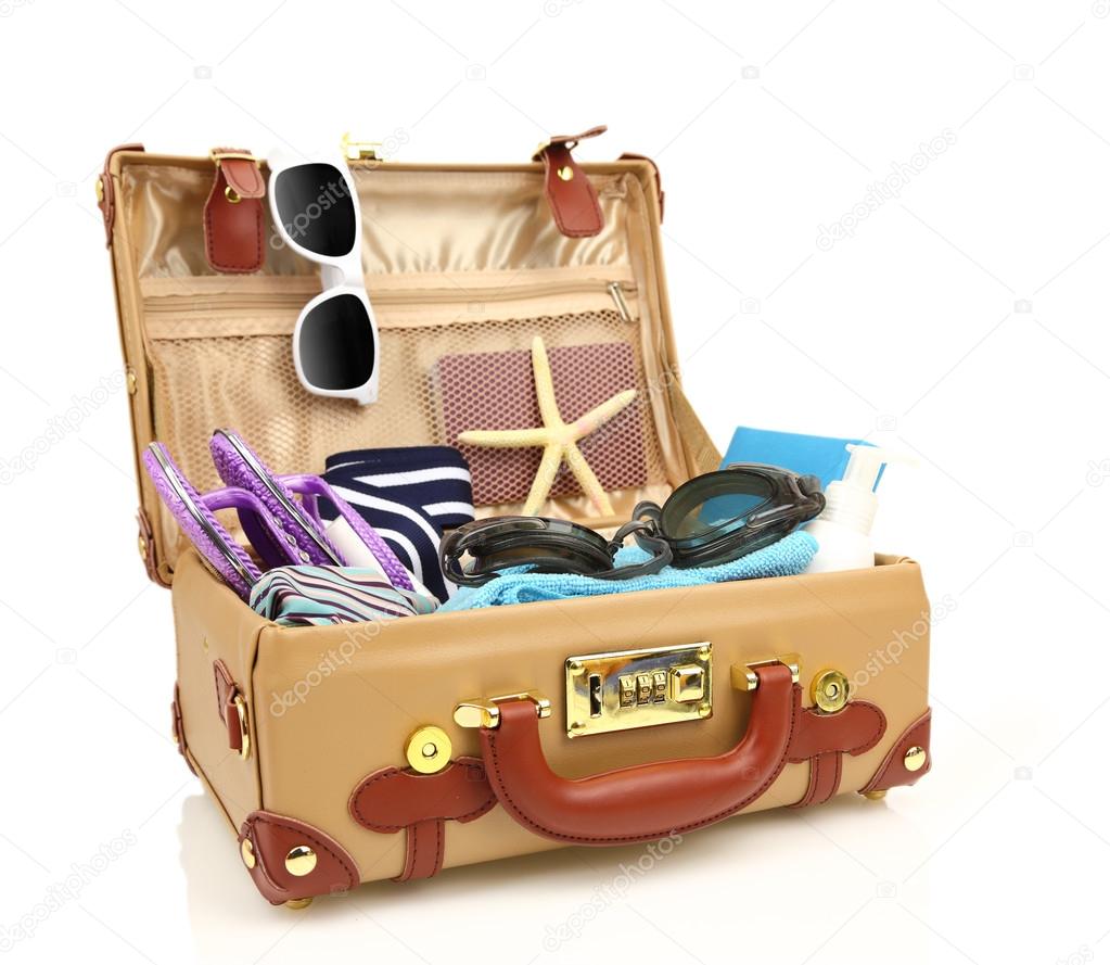 Ready to travel open suitcase with summer equipment isolated 