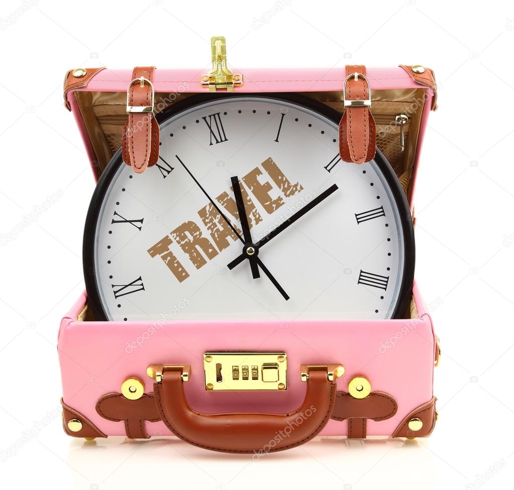Pink travel suitcase with clock inside isolated on white