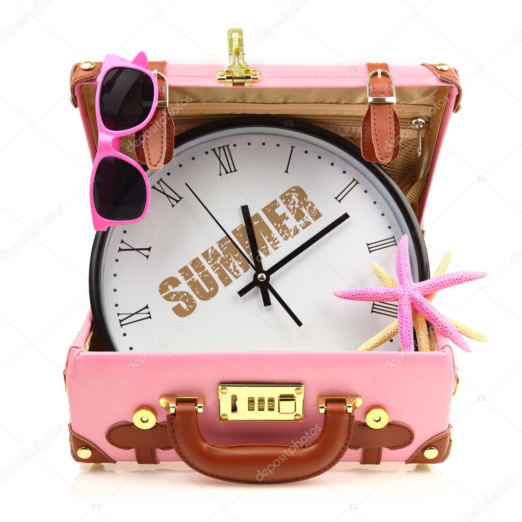 Pink travel suitcase with clock, sunglasses and starfish isolated