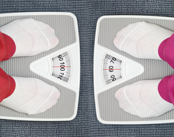 Females feet on bathroom scales