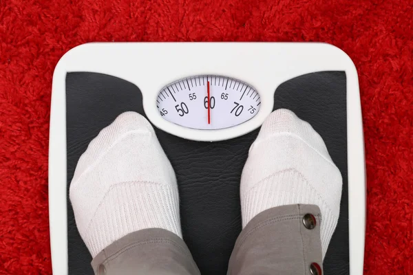 Female feet on bathroom scale — Stock Photo, Image