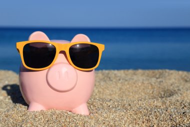 Summer piggy bank on the beach clipart