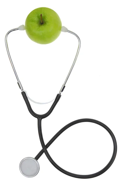 Estetoscopio con manzana verde aislada en blanco — Foto de Stock