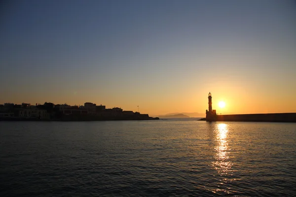 Sunset seascape view of lighthouse and city of Chania Crete