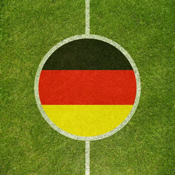 Football field center closeup with German flag in circle — Stock Photo, Image