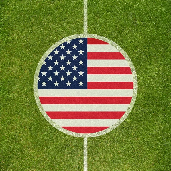 Football field center closeup with American flag in circle — Stock Photo, Image